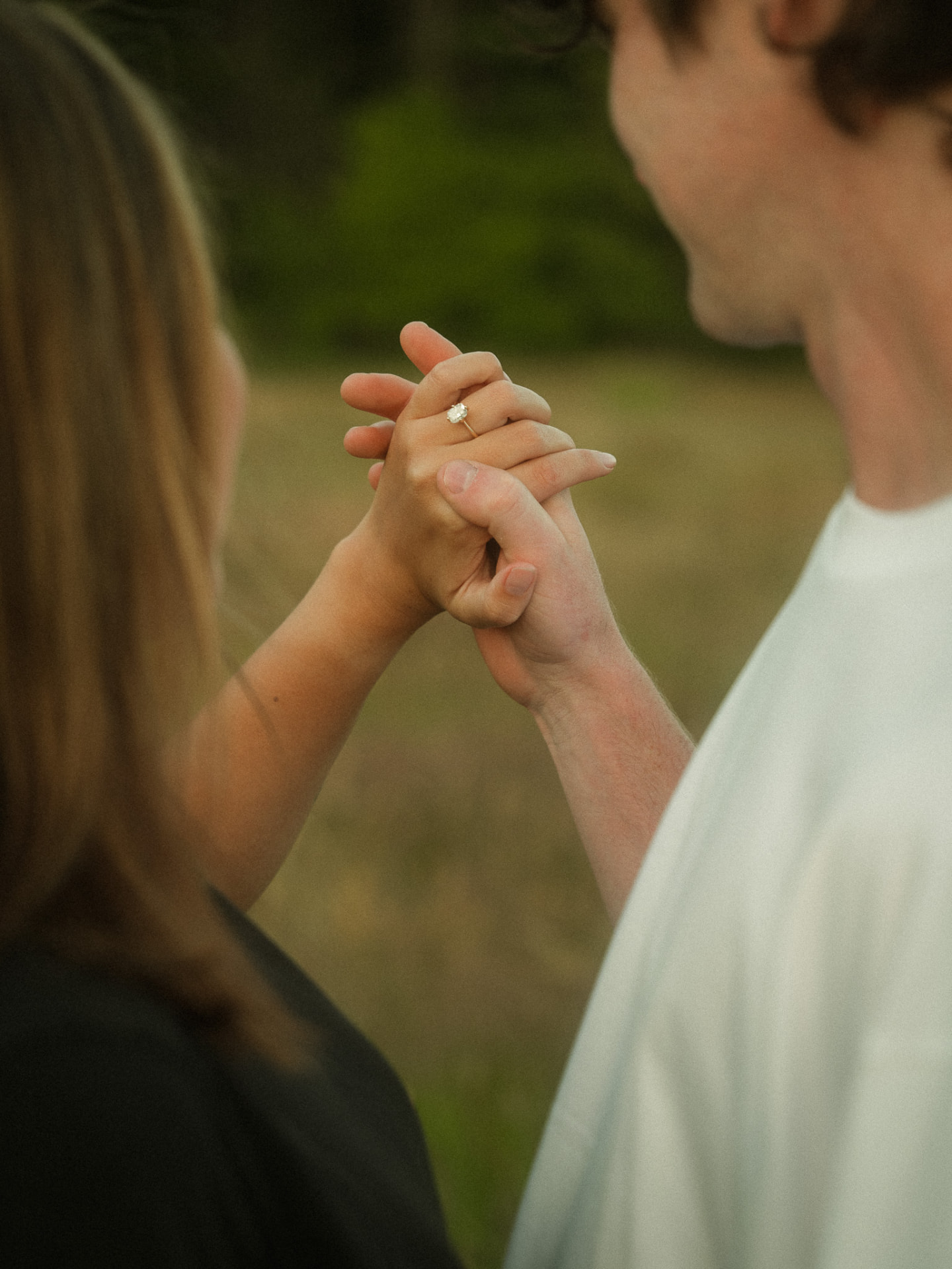 Close-up of an engaged couple holding hands with the ring in focus, Metro Vancouver
