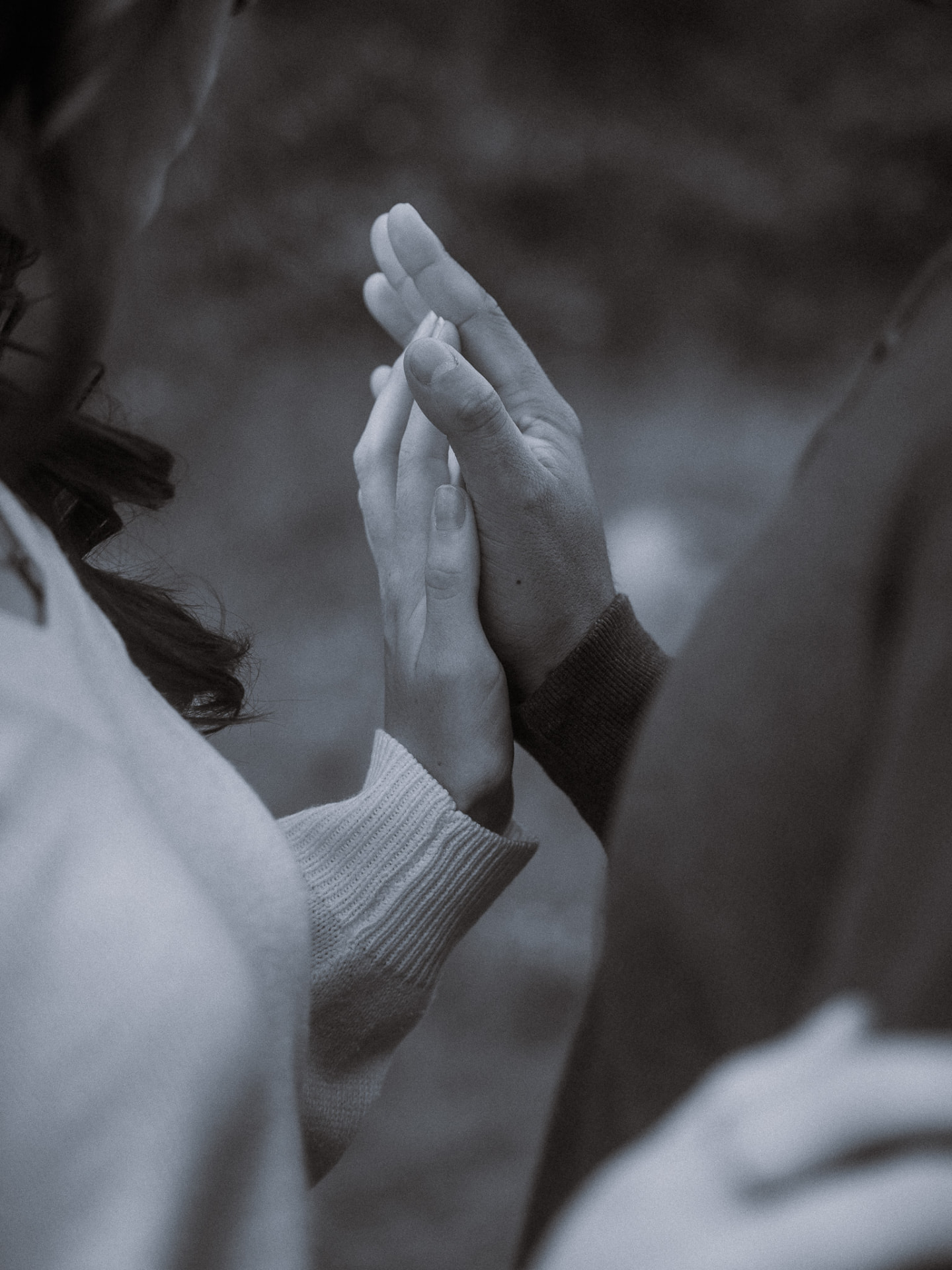Black and white close-up of a couple's hands gently touching during a Metro Vancouver session