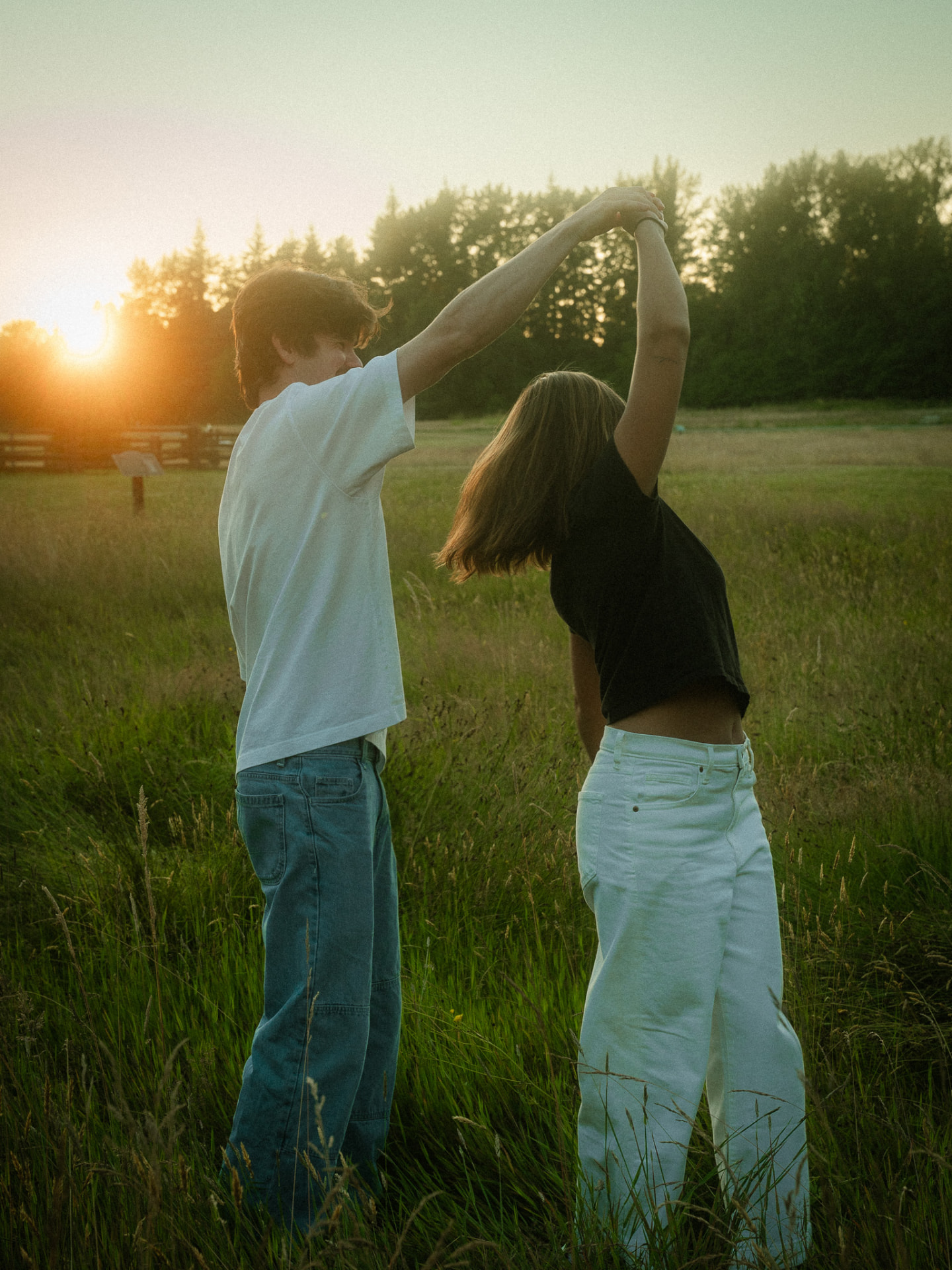 Couple dancing at golden hour in a grassy field in Metro Vancouver