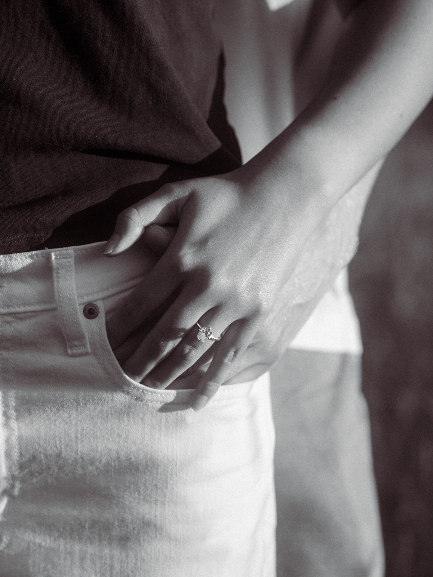 Black and white detail of an engagement ring with a hand in a pocket, Metro Vancouver